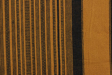 Load image into Gallery viewer, This multi purpose woven fabric features a multi width stripe design in golden brown and black.  It offers beautiful design, style and color to any space in your home.  It has a slightly stiff feel but is workable and durable.  Perfect for window treatments (draperies, valances, curtains, and swags), upholstery, cornice boards, accent pillows and home décor.
