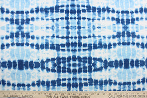  This Solarium outdoor print features a tie die design in blue and white.  This versatile, long-lasting fabric can withstand up to 500 hours of sunlight, water and stain resistant and has 10,000 double rubs.  It is perfect for lounge cushions, pool furniture, tablecloths, decorative pillows and upholstery projects.  This fabric has a slightly stiff feel but is easy to work with.  Bring indoors when not in use. 