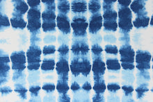 Load image into Gallery viewer,  This Solarium outdoor print features a tie die design in blue and white.  This versatile, long-lasting fabric can withstand up to 500 hours of sunlight, water and stain resistant and has 10,000 double rubs.  It is perfect for lounge cushions, pool furniture, tablecloths, decorative pillows and upholstery projects.  This fabric has a slightly stiff feel but is easy to work with.  Bring indoors when not in use. 
