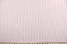 Load image into Gallery viewer, This multi purpose fabric features a classic seersucker stripe in pink and white and offers beautiful design, style and color to any space in your home.  It has a soft workable feel and is durable with 21,000 double rubs.  Perfect for window treatments (draperies, valances, curtains, and swags), upholstery,  bed skirts and accent pillows.  
