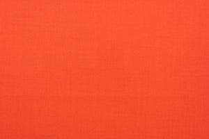This beautiful solid orange fabric has a smooth and lustrous appearance.  The  fabric offers a crisp hand and a stiff but flexible drape.  The glossy finish makes it great for apparel, drapery lining and much more.   