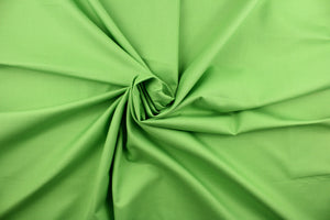 This beautiful solid apple green fabric has a smooth and lustrous appearance.  The fabric offers a crisp hand and a stiff but flexible drape.  The glossy finish makes it great for apparel, drapery lining and much more.   