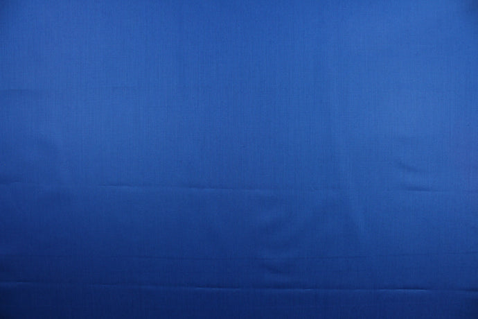 This beautiful solid blue fabric has a smooth and lustrous appearance.  The  fabric offers a crisp hand and a stiff but flexible drape.  The glossy finish makes it great for apparel, drapery lining and much more.   
