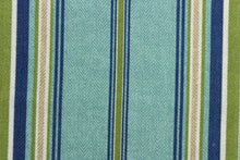Load image into Gallery viewer, This Solarium outdoor print features a striped design in blue, green, khaki and white.  This versatile, long-lasting fabric can withstand up to 500 hours of sunlight, water and stain resistant and has 10,000 double rubs.  It is perfect for lounge cushions, pool furniture, tablecloths, decorative pillows and upholstery projects.  This fabric has a slightly stiff feel but is easy to work with.  Bring indoors when not in use. 
