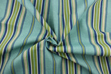 Load image into Gallery viewer, This Solarium outdoor print features a striped design in blue, green, khaki and white.  This versatile, long-lasting fabric can withstand up to 500 hours of sunlight, water and stain resistant and has 10,000 double rubs.  It is perfect for lounge cushions, pool furniture, tablecloths, decorative pillows and upholstery projects.  This fabric has a slightly stiff feel but is easy to work with.  Bring indoors when not in use. 

