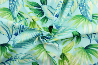 This Solarium outdoor decorative print features a large tropical leaf design in green, white, and blue on a aqua background.  This versatile, long-lasting fabric can withstand up to 500 hours of sunlight, water and stain resistant and has 10,000 double rubs.  It is perfect for lounge cushions, pool furniture, tablecloths, decorative pillows and upholstery projects.  This fabric has a slightly stiff feel but is easy to work with.  