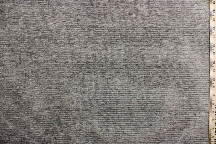 Moraine is a grayish brown chenille high end upholstery weight fabric that is suited for uses that requires a more durable fabric.  The reinforced backing makes it great for upholstery projects including sofas, chairs, dining chairs, pillows, handbags and craft projects.  It is soft and pliable and would make a great accent to any room.  