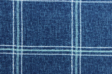 Load image into Gallery viewer, This solarium outdoor print features a plaid design with white and blue green stripes against a denim blue background.  It is durable and can withstand up to 500 hours of sunlight, water and stain resistant and has 10,000 double rubs.  It is perfect for cushions, tablecloths, decorative pillows and upholstery projects.  Bring indoors when not in use.  We offer this fabric in other colors.
