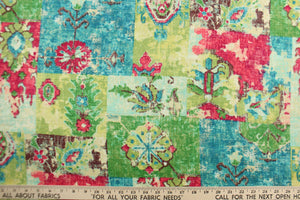 This fabric features a abstract design in  hot pink, lime green, turquoise, green, blue, brown and off white. 