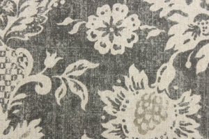 A beautiful medallion design in varying shades of gray against a dull off white. 