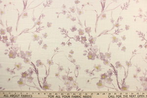  This fabric features a floral design in pale purple, and hints of gold against off white.