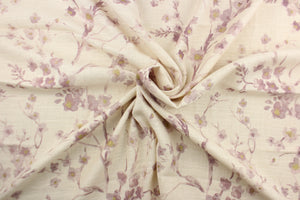  This fabric features a floral design in pale purple, and hints of gold against off white.