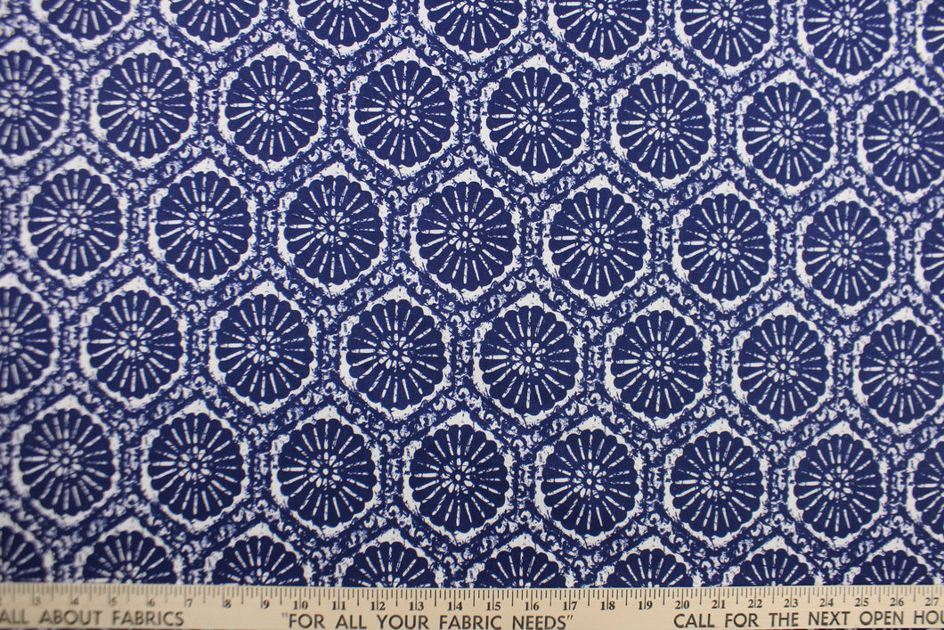 This fabric features a sand dollar design in rich indigo blue . 