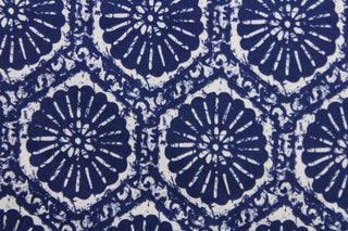 This fabric features a sand dollar design in rich indigo blue . 