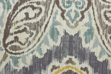 Load image into Gallery viewer, Artesanias is an ikat damask fabric that features an eye-catching taupe, teal, coral and mustard pattern on an off white background.  The versatile fabric is perfect for window accents (draperies, valances, curtains and swags) cornice boards, accent pillows, bedding, headboards, cushions, ottomans, slipcovers and light duty upholstery.  With a 51,000 double rub rating, this fabric provides exceptional durability and high wear resistance.
