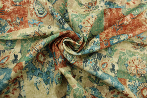 This fabric features a abstract design in  beige, tan, blue, golden tan, seafoam green, and terracotta. 