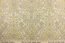 Load image into Gallery viewer, This fabric features an Aztec design in  yellow with gray outline against a natural background. 

