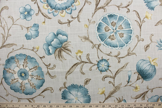 Roundelay offers a timeless floral and vine print with hints of blue and stone against a light warm gray background. The fabric is soil and stain repellant, protecting against everyday wear and tear for a long lasting look.  The versatile fabric is perfect for window accents (draperies, valances, curtains and swags) cornice boards, accent pillows, bedding, headboards, cushions, ottomans, slipcovers and light duty upholstery.  