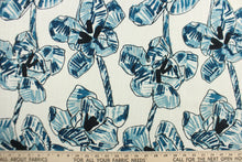 Load image into Gallery viewer, This fabric features a floral design in  varying shades of blue, black and hints of gray against a dull white background.
