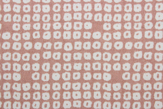 Axel is a multi use fabric featuring a geometrical design in blush and white with a soil and stain repellant finish.  It can be used for several different statement projects including window accents (drapery, curtains and swags), decorative pillows, hand bags, bed skirts, duvet covers, upholstery and craft projects.  It has a soft workable feel yet is stable and has a durability rating of 51,000 double rubs.
