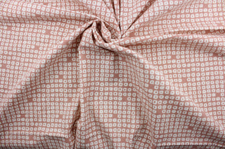 Axel is a multi use fabric featuring a geometrical design in blush and white with a soil and stain repellant finish.  It can be used for several different statement projects including window accents (drapery, curtains and swags), decorative pillows, hand bags, bed skirts, duvet covers, upholstery and craft projects.  It has a soft workable feel yet is stable and has a durability rating of 51,000 double rubs.