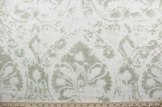  Crafted from a blend of linen and rayon, this fabric features a striking large print damask pattern in shades of green and white. Tested to exceed 51,000 double rubs, this fabric is ideal for projects that require durability.  It can be used for several different statement projects including window accents (drapery, curtains and swags), decorative pillows, hand bags, bed skirts, duvet covers, upholstery and craft projects.  