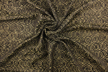 Load image into Gallery viewer, This fabric features interlocking circles in brown and dull gold.  It has a soft drapable hand and would be ideal for swags, window scarves and drapery panels.
