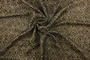This fabric features interlocking circles in brown and dull gold.  It has a soft drapable hand and would be ideal for swags, window scarves and drapery panels.