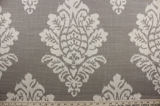 Croydon is a premium fabric designed for durability.  It is a blend of cotton and linen that features a slubby basket medallion print.  This fabric is rated to 12,000 double rubs and is a sophisticated shade of beige on a dark taupe background.  It can be used for several different statement projects including window accents (drapery, curtains and swags), decorative pillows, hand bags, bed skirts, duvet covers, upholstery and craft projects.  