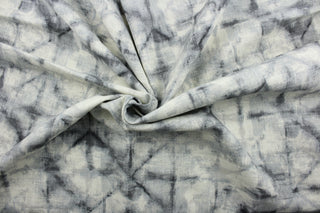 This fabric is a blend of cotton and linen with graphite hues featuring a shibori style print.  It can be used for several different statement projects including window accents (drapery, curtains and swags), decorative pillows, hand bags, bed skirts, duvet covers, upholstery and craft projects.  It has a soft workable feel yet is stable and has a durability rating of 20,000 double rubs.