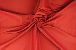 This taffeta fabric in deep orange is lightweight, smooth and crisp and features an iridescent sheen.  Uses include evening gowns, jackets, skirts, blouses, curtains and home interior decorations.