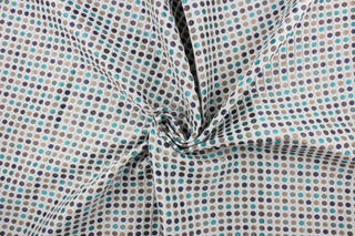 This fabric features a geometric design in blue, teal, turquoise, tan, and brown set against a pale gray. 