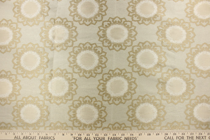 This fabric feature a medallion design in beige and tan .