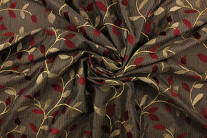  This fabric features a embroidery vine and leaf design in dark red, gold and tan against a dark brown . 