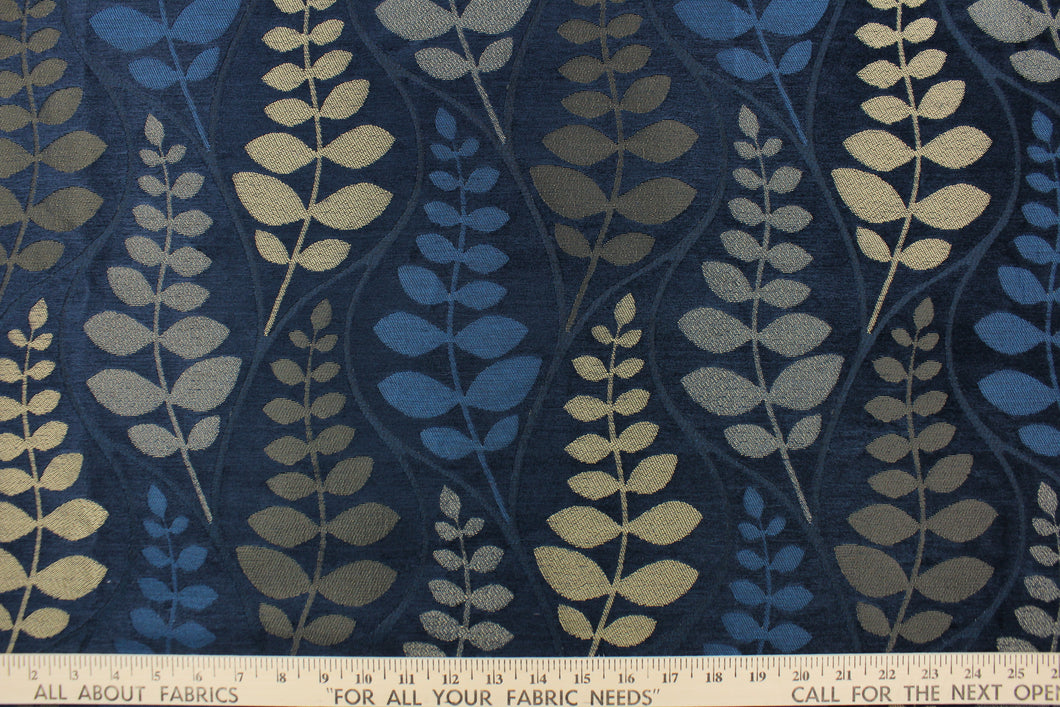 This fabric features a leave design in  gold tone set against a rich blue . 