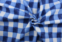 Load image into Gallery viewer,  Painterly Plaid is perfect for outdoor environments.  It features a classic buffalo check pattern in the shades of blue and white, and has a durability rating of 13,000 double rubs. This upholstery fabric is stylish, sturdy, and sure to stand the test of time.  Uses include cushions, tablecloths, upholstery projects, decorative pillows and craft projects. This fabric has a slightly stiff feel but is easy to work with.  
