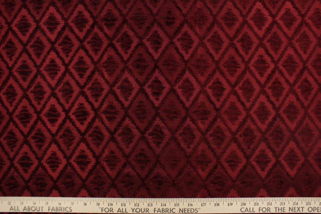  This fabric features a diamond design in rich burgundy  . 