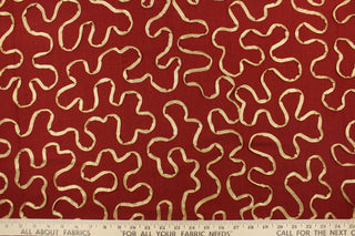 This fabric features a scroll design in gold set against a rich red . 