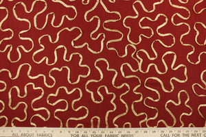 This fabric features a scroll design in gold set against a rich red . 
