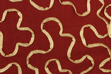 Load image into Gallery viewer, This fabric features a scroll design in gold set against a rich red . 
