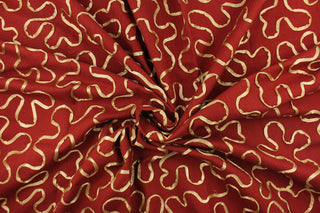 This fabric features a scroll design in gold set against a rich red . 