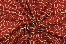 Load image into Gallery viewer, This fabric features a scroll design in gold set against a rich red . 
