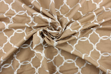 Load image into Gallery viewer, This fabric features a embroidery lattice design in a shiny dull white against a tan background.
