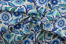 Load image into Gallery viewer, Fiesta Floral is a great pick for outdoor spaces.  It features a unique floral pattern in shades of blue, sand, and white.  This fabric is mildew, water, and stain resistant and also tested to withstand 500 hours of direct sunlight and 33,000 double rubs - making it both beautiful and durable.  Uses include cushions, tablecloths, upholstery projects, decorative pillows and craft projects. This fabric has a slightly stiff feel but is easy to work with.  
