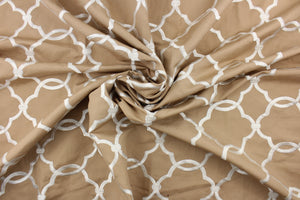 This fabric features a embroidery lattice design in a shiny dull white against a tan background.