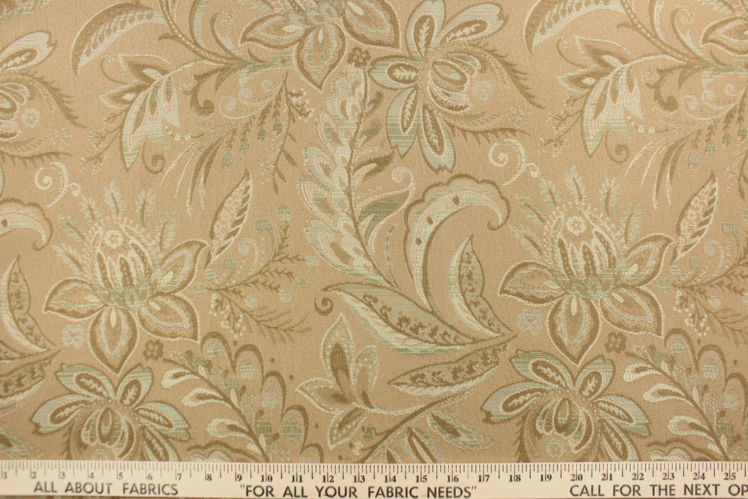  This tapestry features a floral design in seafoam green, tan and beige set against a rich khaki color . 