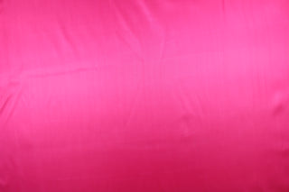 A beautiful satin fabric in a hot pink color