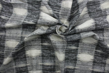 Load image into Gallery viewer,  Sashika Plaid features a beautiful multi-use ethnic plaid pattern, consisting of shades of grey and off white.  Offering up to 24,000 double rubs, this upholstery fabric ensures long-lasting durability and quality.  Uses include window treatments, pillow shams, duvet covers, toss pillows, slip covers, and light duty upholstery to create a complete interior design look.
