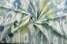 Load image into Gallery viewer, Lagrande is a multi use fabric featuring an ikat print design in blue, green and ivory.  The fabric is treated with a soil and stain repellant finish for lasting performance, rated for up to 15,000 double rubs.  The versatile fabric is perfect for window accents (draperies, valances, curtains and swags) cornice boards, accent pillows, bedding, headboards, cushions, ottomans, slipcovers and upholstery.  
