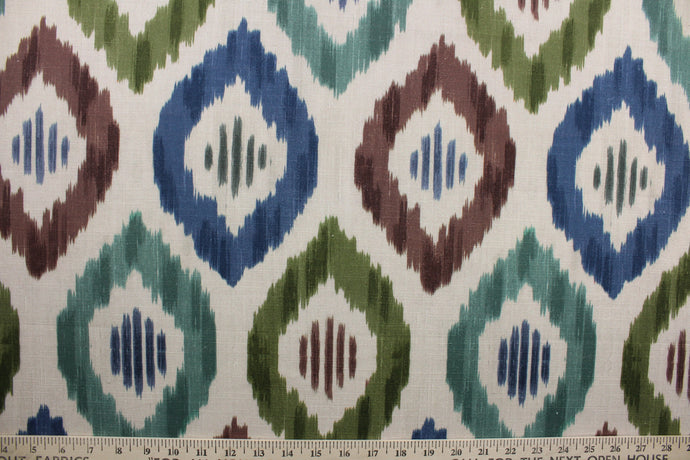 Aura features a multi-use geometric ikat design in shades blue, green and brown set against a bold khaki background. This durable fabric is rated for 30,000 double rubs. The versatile fabric is perfect for window accents (draperies, valances, curtains and swags) cornice boards, accent pillows, bedding, headboards, cushions, ottomans, slipcovers and upholstery.  